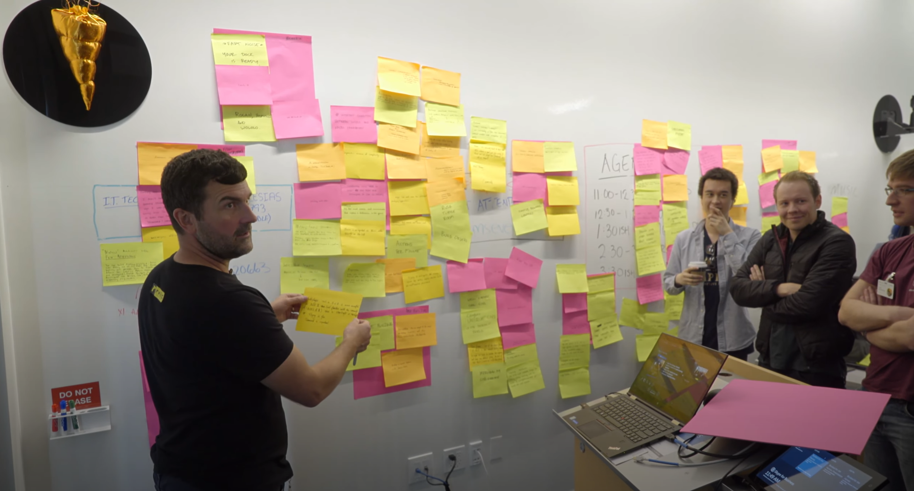 Community council members looking at a wall of post-it notes